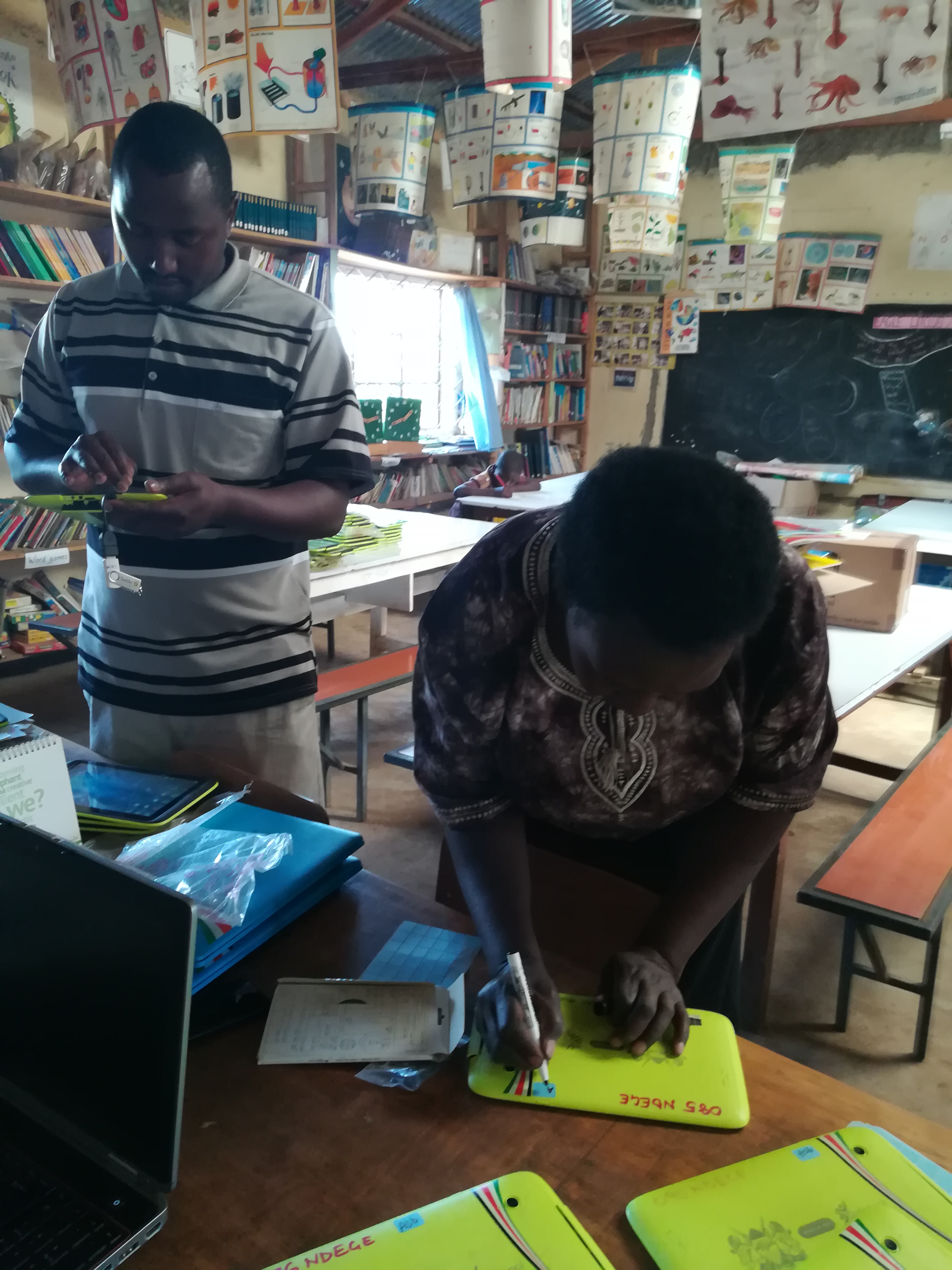 Teachers labelling tablets during a visit to Ngede Primary School in 2017